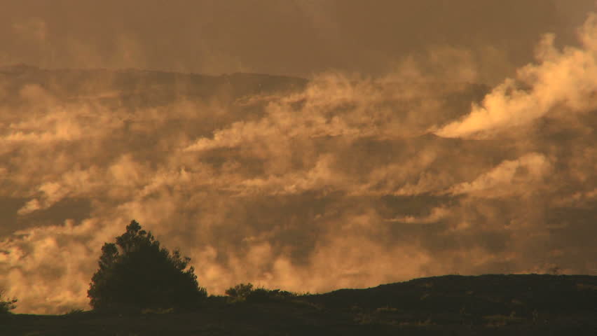 Hot steam energy escaping from a barren rocky volcanic crater 