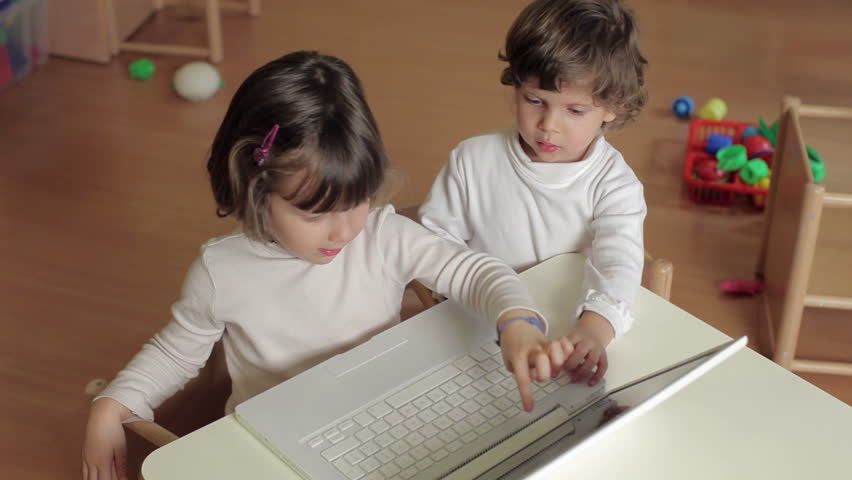 multiple shots of 2-3 years old girls playing with pc in kindergarten. 