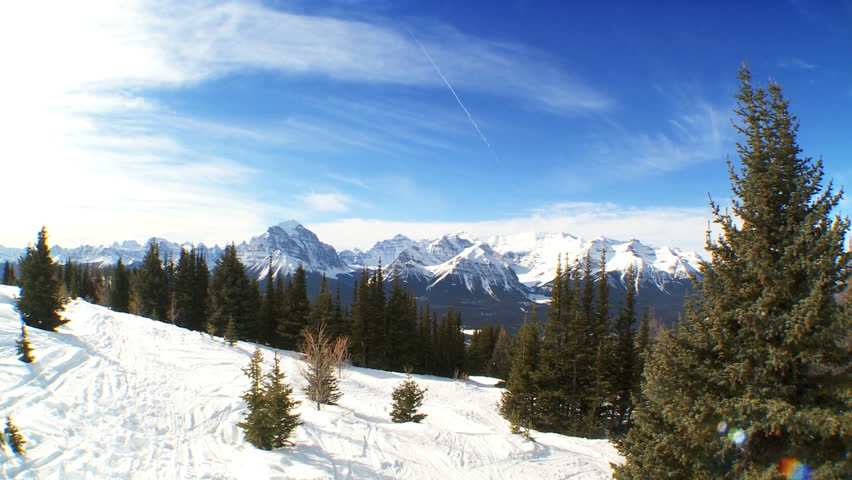 Crossed downhill carver skis standing in fresh clean snow in snowy mountain landscape
