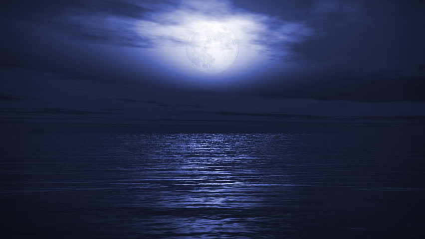 Full Moon In A Clear Night Sky With The Stars Twinkling Over A Calm