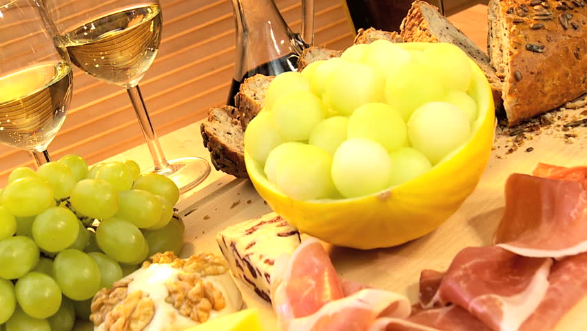 Delicious selection of cheese, oils, fruit & parma ham served with white wine