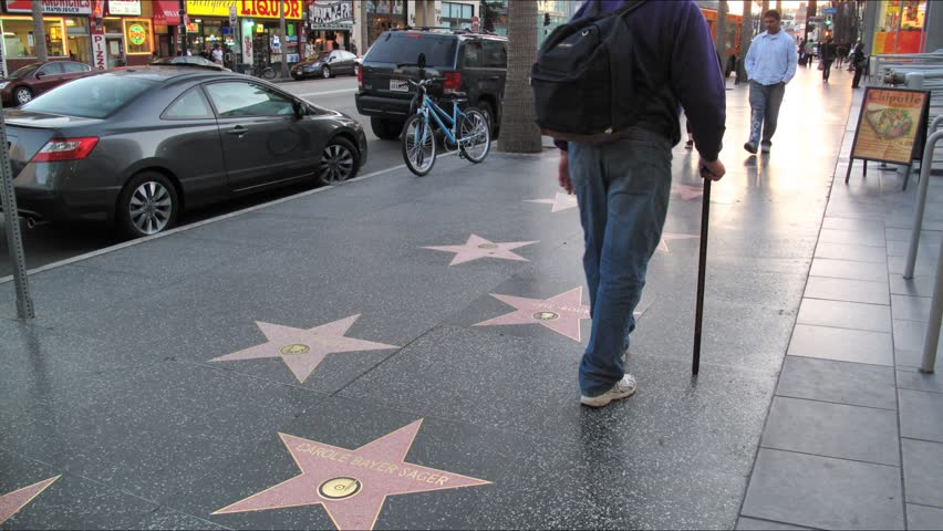 LOS ANGELES - APRIL 6: People walking on famous Walk of Fame at Hollywood Blvd. HD Time lapse. April 6, 2010 in Los Angeles, California.