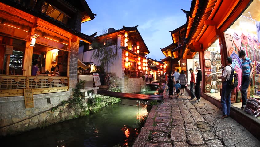 LIJIANG, CHINA - AUGUST 20: In the peak of the season, Chinese and world travelers enjoy old town Lijiang including old architecture, restaurants and the local river in Yunnan, August 20, 2009