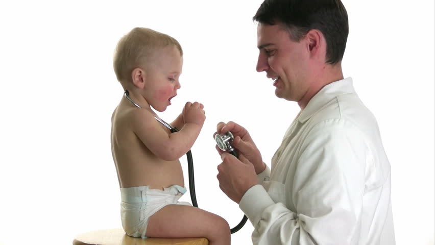 Friendly doctor plays with a baby, isolated on white.