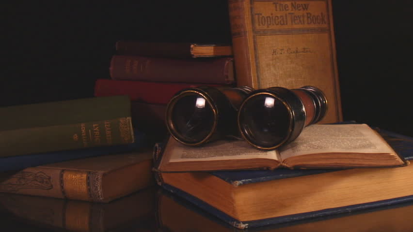 Vintage binoculars and books with black background- hd