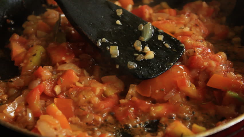 A chef tossing red bean into the pan 