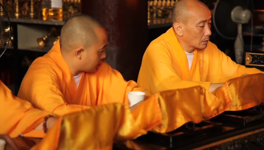 LESHAN, CHINA - AUGUST 24: Buddhist monks performing ceremony inside Baoguo monastery, Leshan, Sichuan, China, August 24, 2009