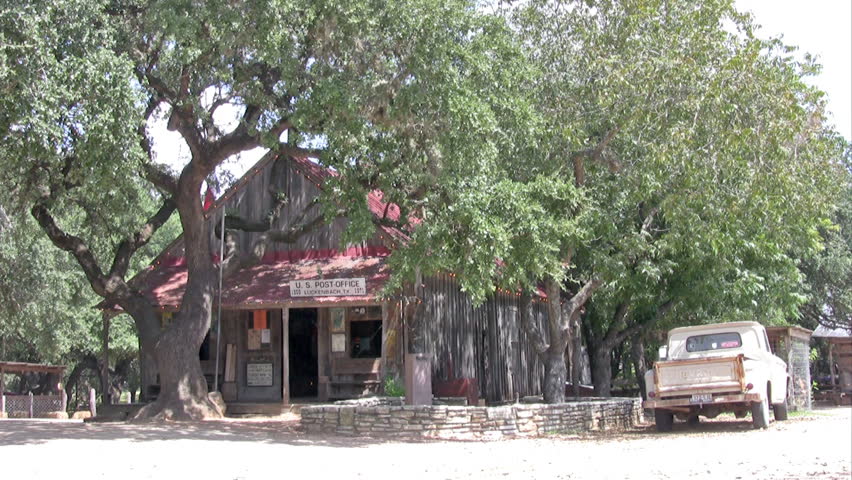 Video of Luckenbach Texas made famous by Waylon Jennings song. Post office with three residents. Large oak trees and now a dance hall and tourist area.Building under a large oak tree. 