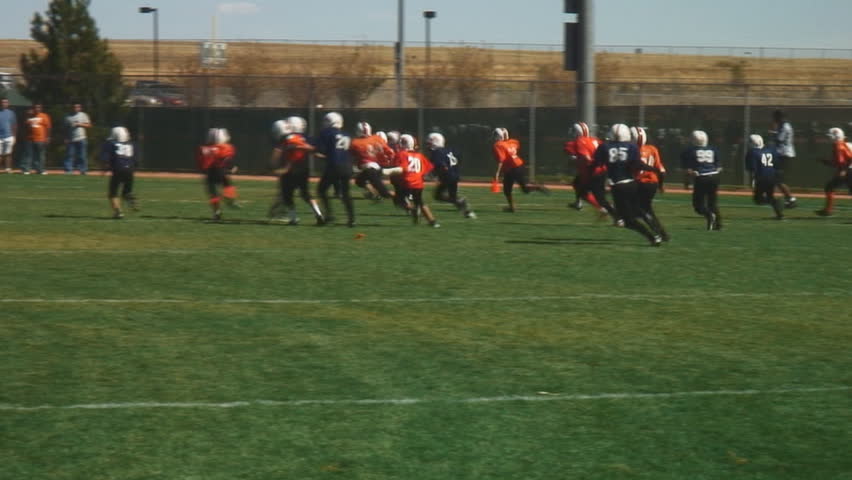 Youth football teams enjoy full contact game-kickoff touchdown play; HD, audio 
