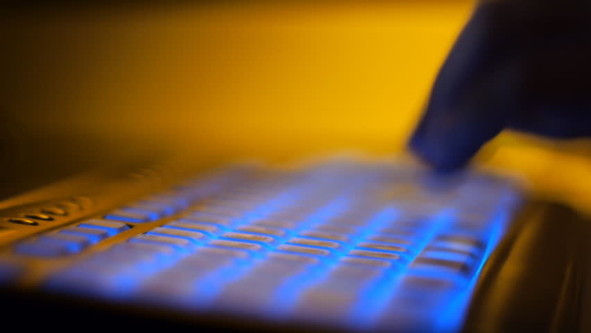 Sequence of macro shots of typing under colored lights