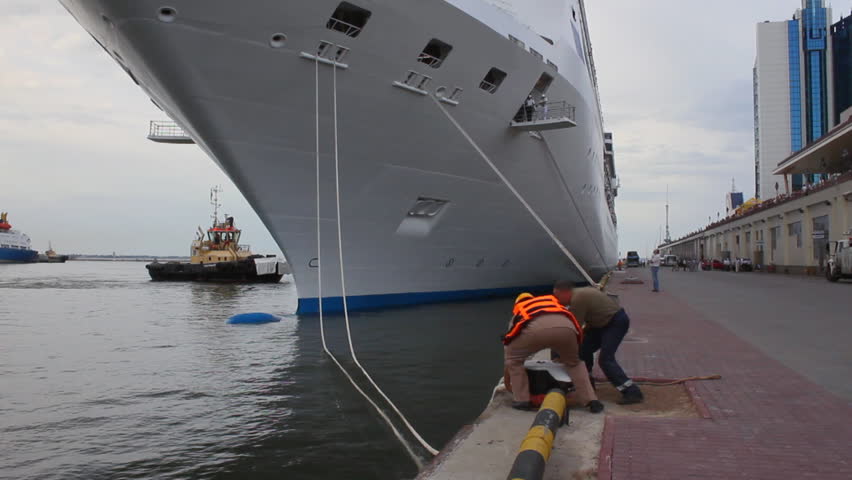 Harbor dock workers prepares cruise liner for departure
