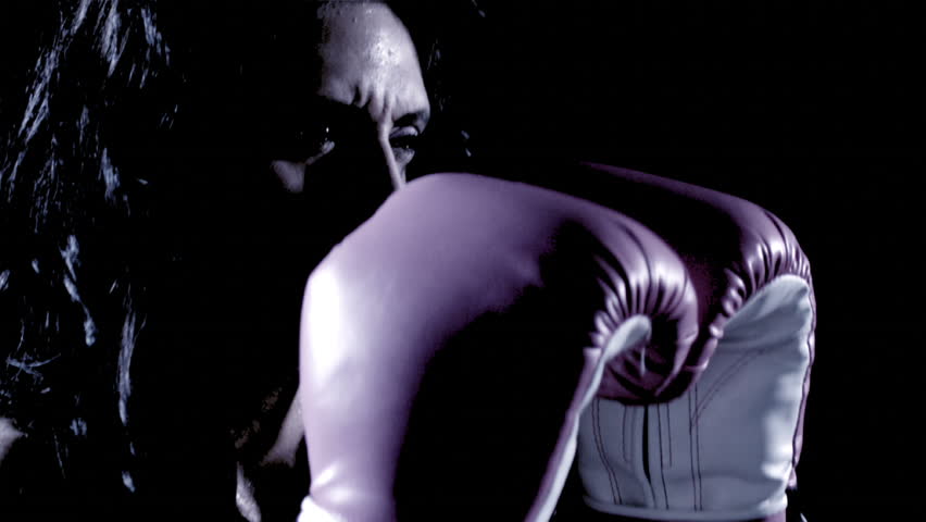 A Latino woman boxes.