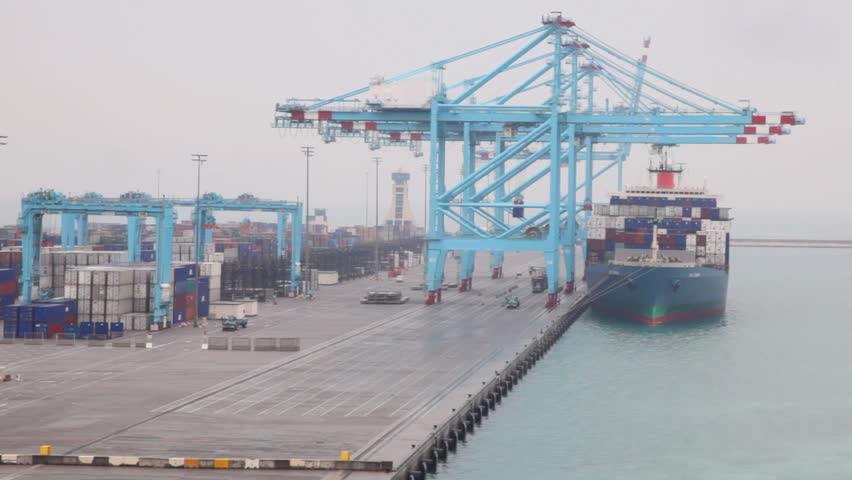 barge with containers stopped in seaport during shipment