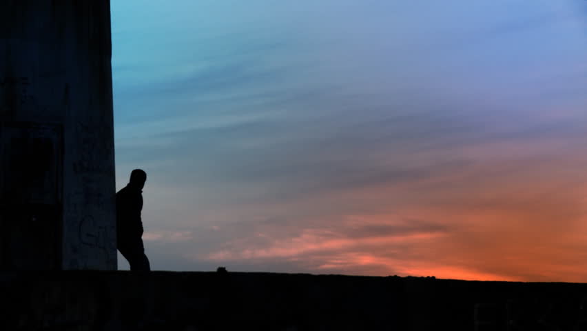 Alone man standing towards sunset/sunrise. Full HD, 1080p, 1920x1080.