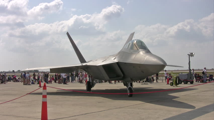 Video of F-22 Raptor aircraft during an airshow at Randolph AFB Texas. Spectators walking about and enjoying the view. USAF high performance new fighter aircraft.  Three video views