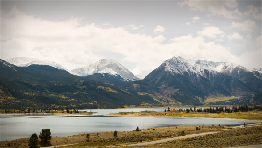 Autumn Early Snow Storm - Sunrise Timelapse of Mountains and Aspen. Great for themes of nature, travel, wilderness, seasons, weather, mountains, exploration, outdoor recreation, adventure.