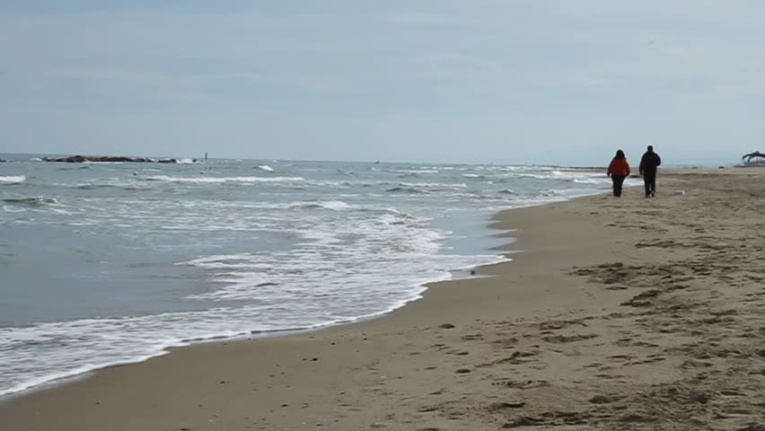 Mature couple walking near the sea 