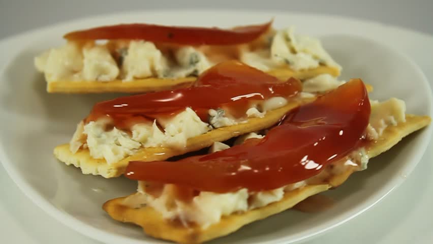 Snack on crackers with gorgonzola blue cheese and quince jam 