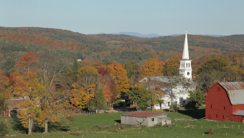 Late afternoon autumn view of a church and farm in Peacham, Vermont.
