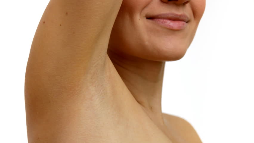 Young woman stroking her clean armpit  