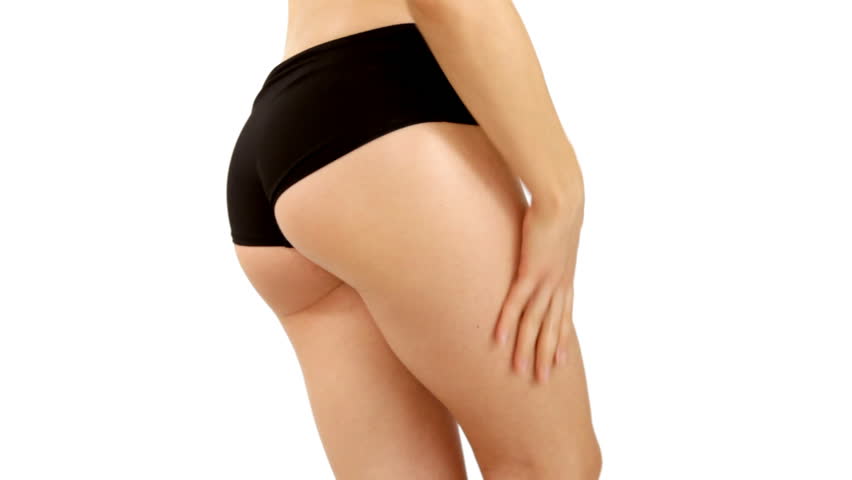 Woman applying moisturizer cream on her thigh, isolated on white 