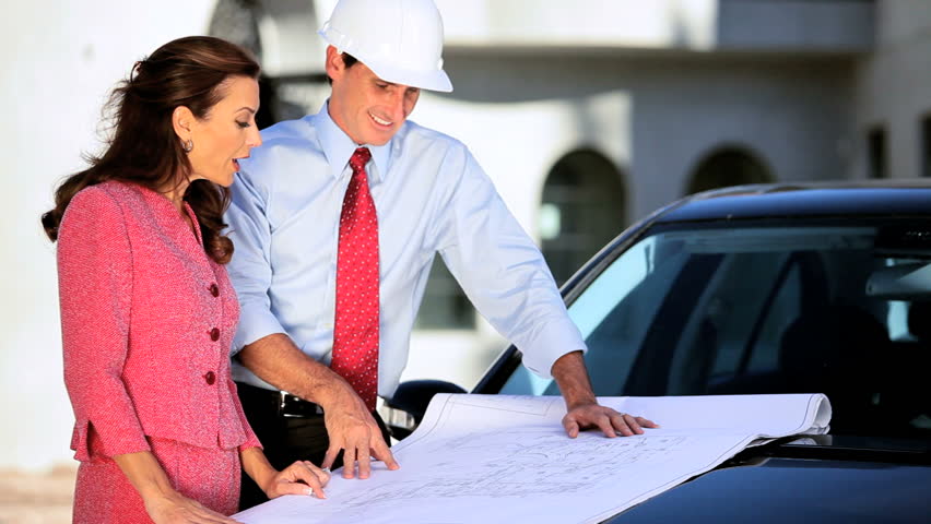 Female client and her architect checking on the progress of construction