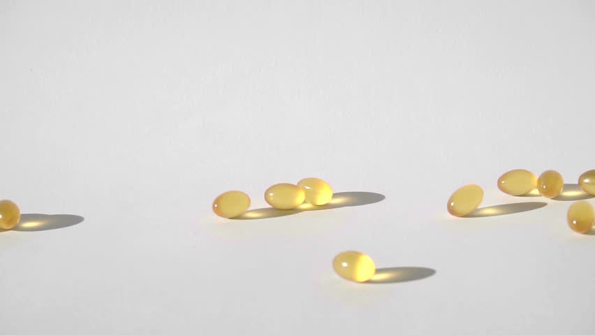 Pills Falling On White Background Stock Footage Video (100% Royalty
