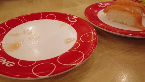 Kuching, Malaysia - May 2019. Pov Of A Man Eating Salmon Nigiri Sushi At  Sushi King Restaurant