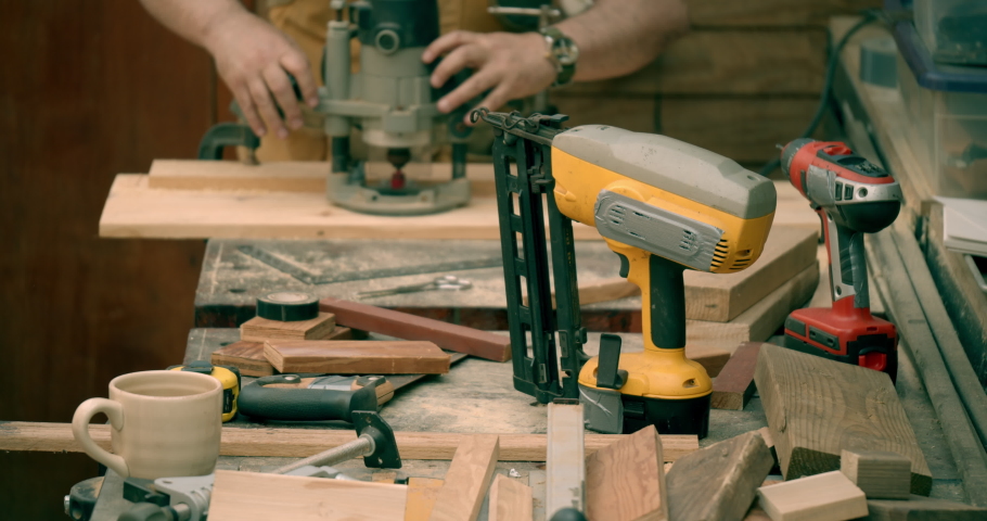 Woodworker Soft Focus Working In Background Tools On Workbench