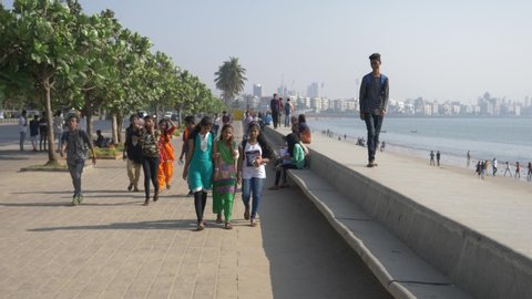 Mumbai/india - 01.01.2019, young contemporary indian people iare walking  down the street near mumbai beach