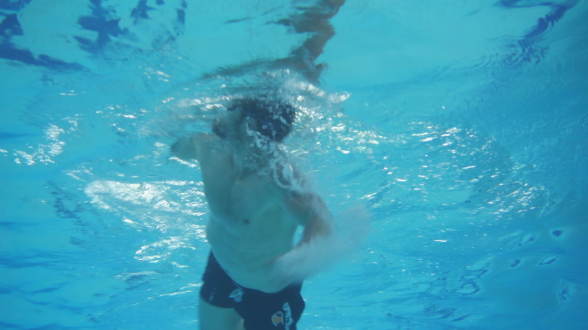 Underwater Low Angle Shot Of Man Swimming With Freestyle Technique