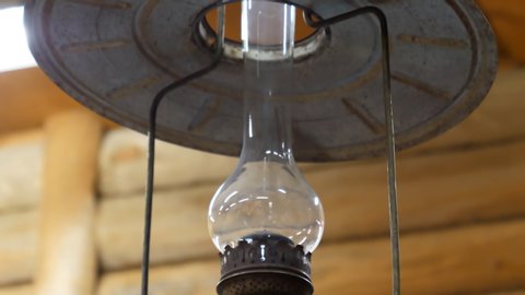 Close Up View Of Kerosene Lamp Suspended From Ceiling Tilt Down Shot