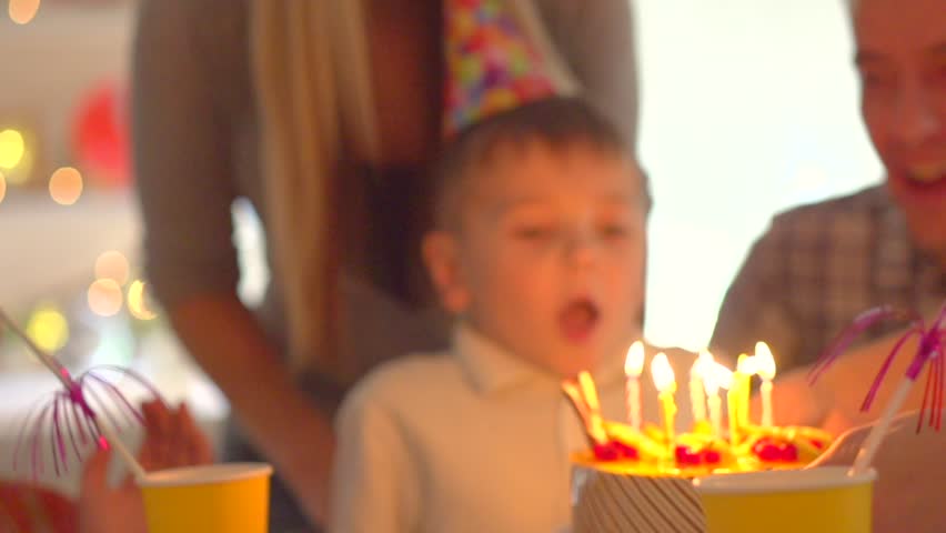 Hd00 27little Boy Blows Out Candles On Birthday Cake At Party