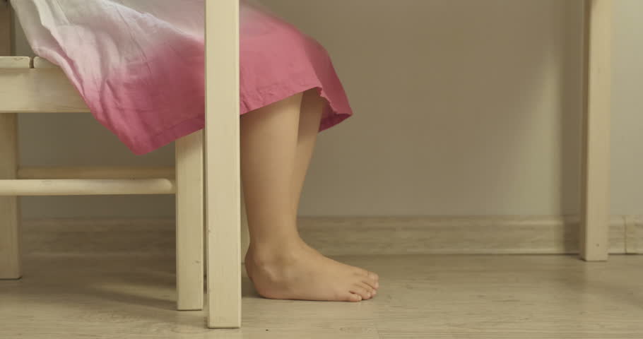 Little Girl In Dress Sitting Stock Footage 100 Royalty Free Little Girl In Dress Sitting At The Kids Table Moves His Bare Feet On Floor Frame Only Legs Under
