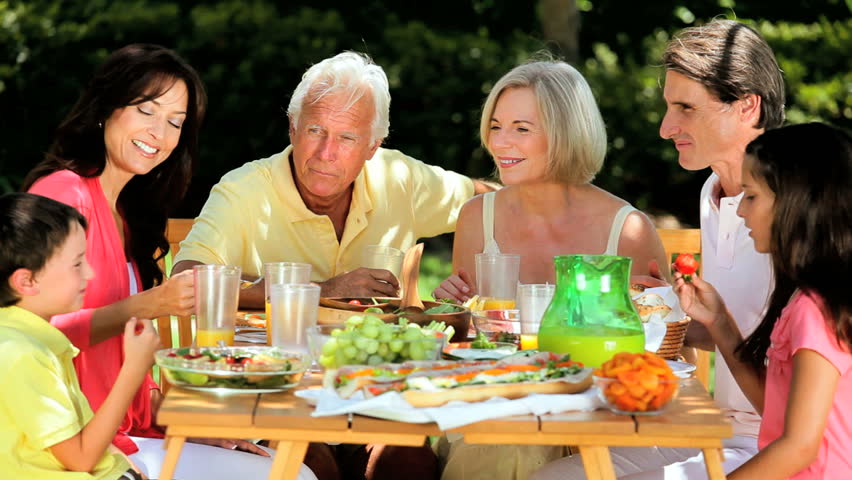 Grandparents Being Joined By Their Children & Grandchildren As They Sit ...