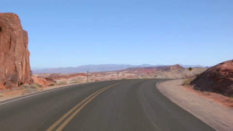 Driving USA: point of view car shot of magnificent desert landscape in Valley of Fire, Nevada