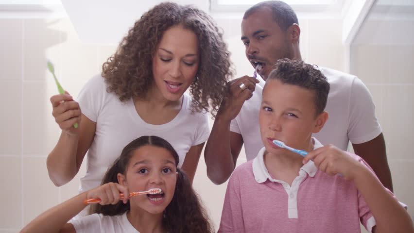 A Mother Helps Her Son Brush His Teeth Stock Footage Video 16252534