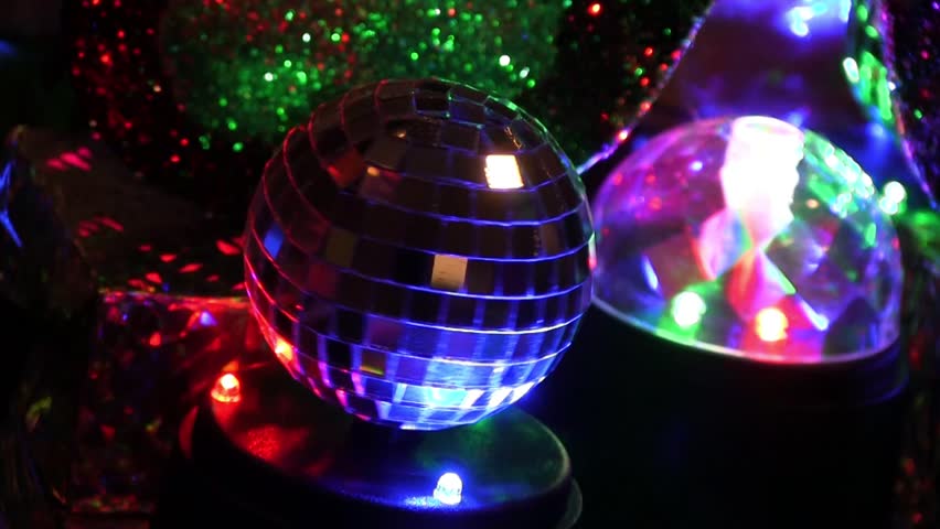 Miniature Mardi Gras Disco Ball Spinning Around Next To Other Table