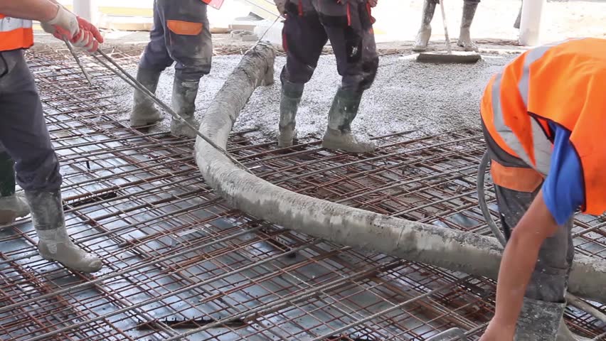 Workers Are Spreading Concrete Over Stock Footage Video 100 Workers Are Spreading Concrete Over Reinforced Floor On The Construction Site Pouring In Building Foundation