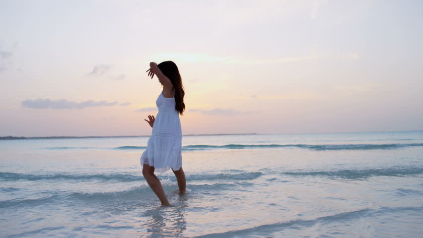 Girl in a white dress walking on the beach images Girl in a white dress walking on the beach images