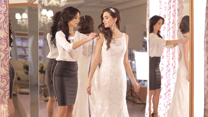 Hd00 19the Consultant Helps The Girl To Choose A Wedding Dress