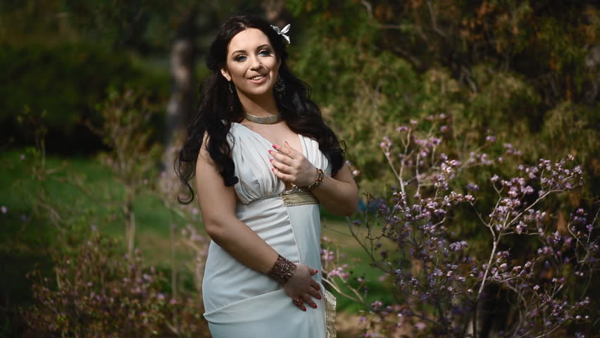 Young Brunette Caucasian Woman In White Dress Pose Near The Blooming ...