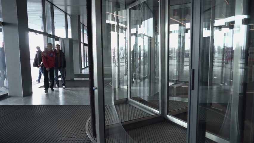 Two Businessmen Meet And Shake Hands In A Meeting Room Business Ufa Russia 05 06 2017 People Enter Into Rotating Spinning Revolving Glass Doors