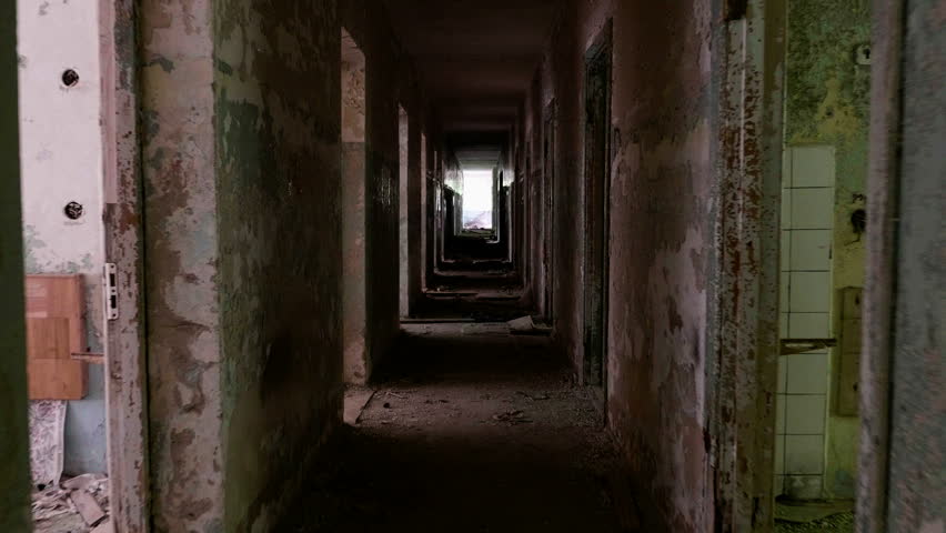 An Abandoned Hallway With Crumbling Bricks And Debris In A