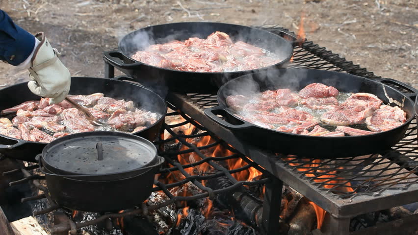 Bbq Lamb And Mutton Steaks Chops Cooking In Cast Iron Pans Bbq Lamb And Mutton Steaks Chops Cooking In Cast Iron Pans Over An Open Outdoor Fire Cowboy Sheep Camp Party Fresh Meat With Smoke Oil