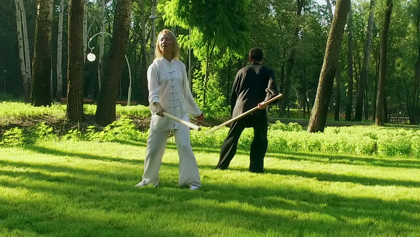Qigong Exercise With A Wooden Stick Young Man And Woman Exercise With A Wooden Stick Young Man And Woman Practicing Elements Of Qigong Slow Motion Hd
