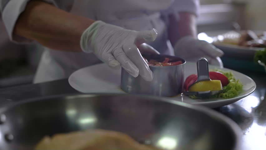 Restaurant Kitchen Video chef prepares a dish in a restaurant kitchen stock footage video Restaurant Kitchen Video chef prepares a dish in a restaurant kitchen stock footage video