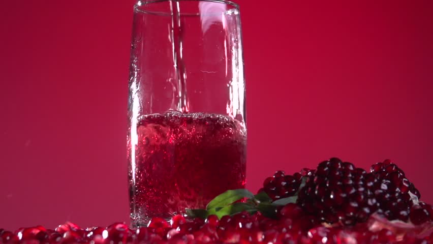 Garnet. Pomegranate Juice Is Poured Into A Glass. Slow Motion 240 Fps. High Speed Camera Shot ...