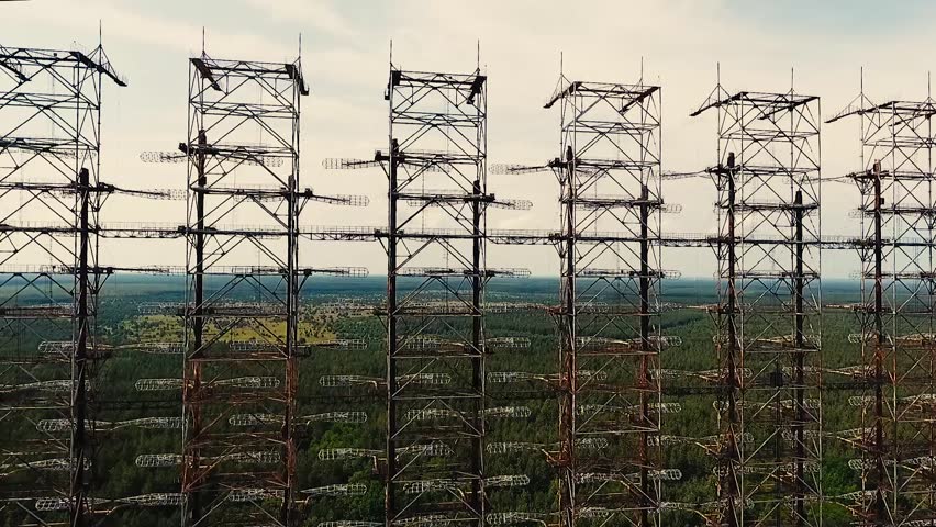 Electric Pylons At Sunset With Timelapse Clouds Passing By. Stock ...