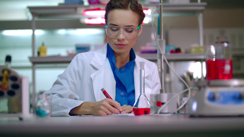 4K Teacher In Science Classroom Looking At DNA Model. Shot On RED Epic ...